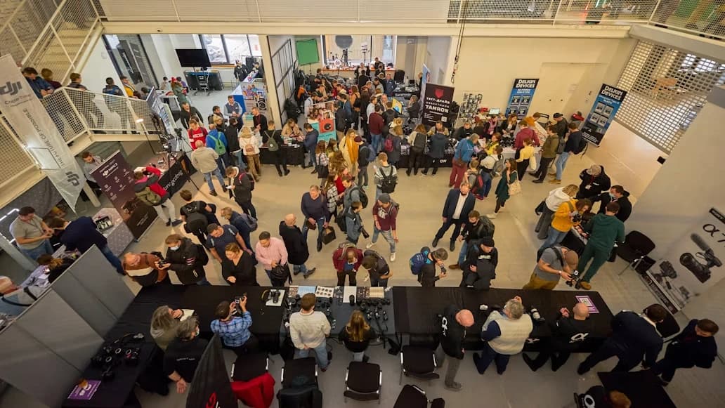 An exhibition hall seen from above, busy with people between stands